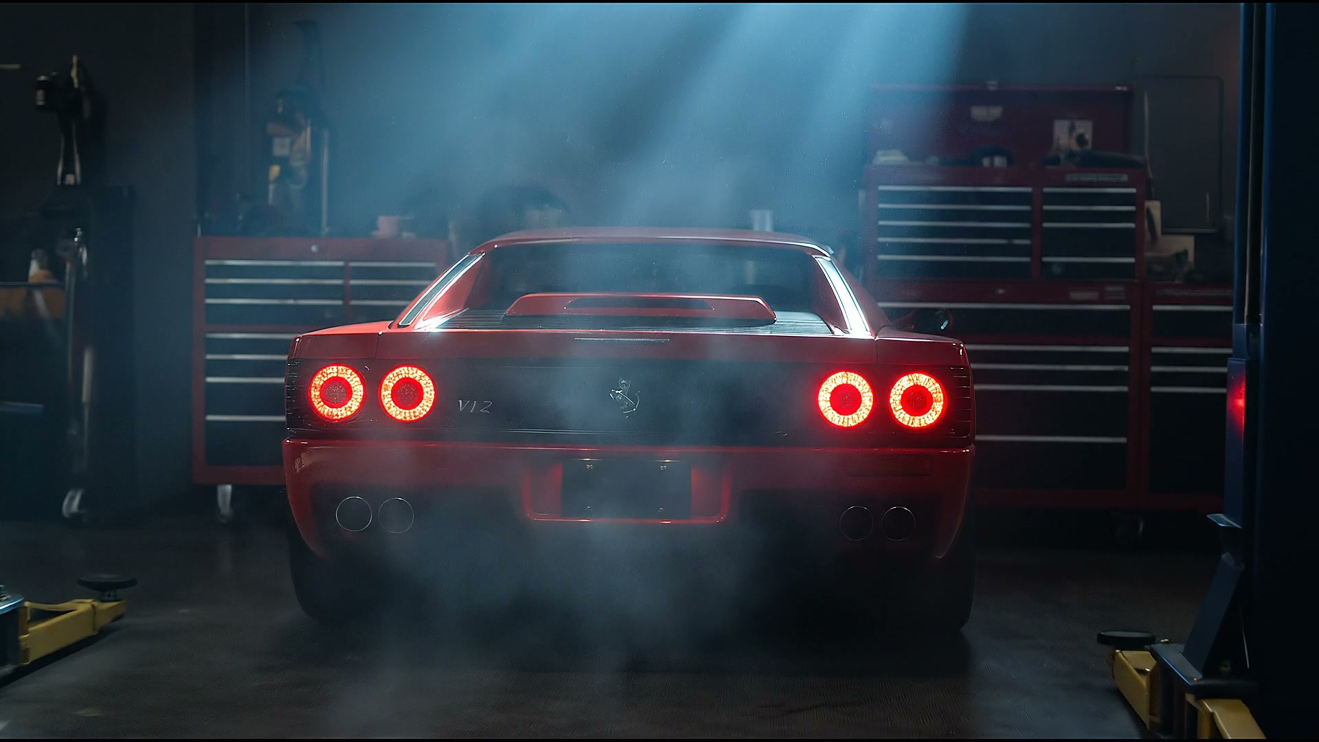 Red Ferrari-style berlinetta in a dark specialist workshop, tail lights glowing, exhaust haze rising